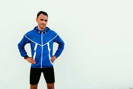 Portrait of handsome man runner in the city. Fitness, workout, sport, lifestyle concept.