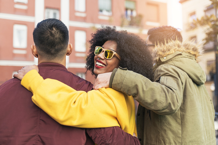 Group of happy friends walking in the street. Friendship concept.の写真素材