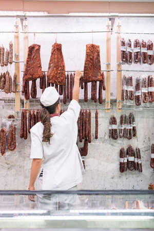 Pretty Butchery Woman working in butchery shop.の写真素材
