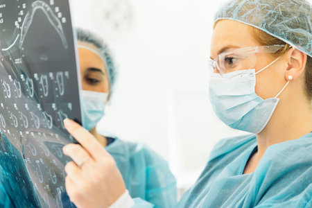 Dentist showing something to her colleague on x-ray image. Dentist Concept