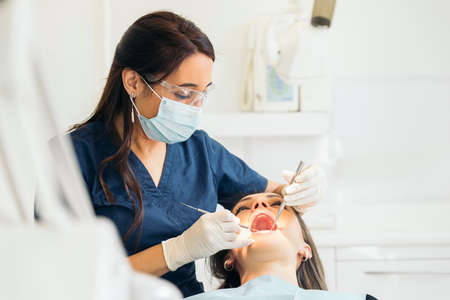 Dentists with a patient during a dental intervention. Medical Concept.の写真素材