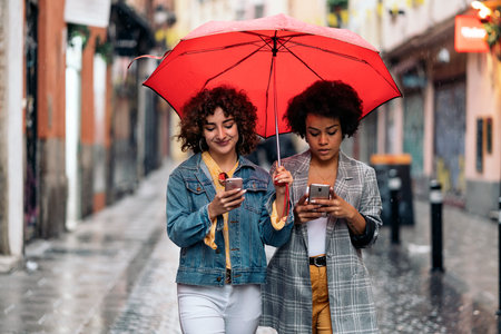Happy Friends Using Phone in the Street