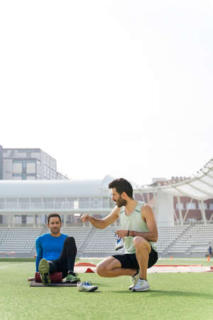 Athletes Stretching in Athletic Trackの写真素材