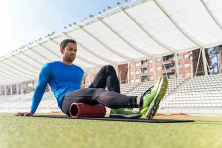 Black Athlete Stretching in Sports Trackの写真素材