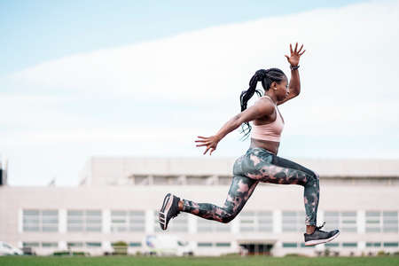 African-American young athlete sprinter jumpingの写真素材