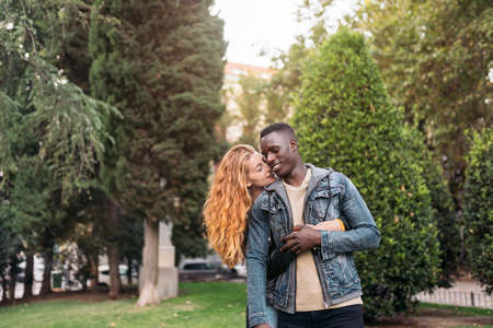 Young Multiethnic Couple Hugging and Lovingの写真素材