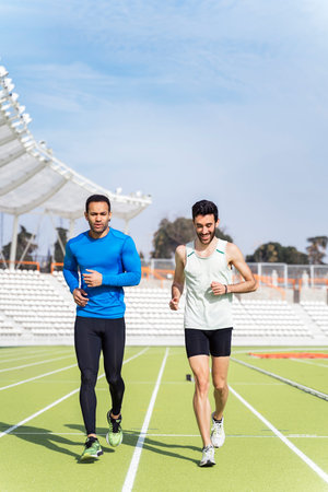 Front View of Two Athletes Running