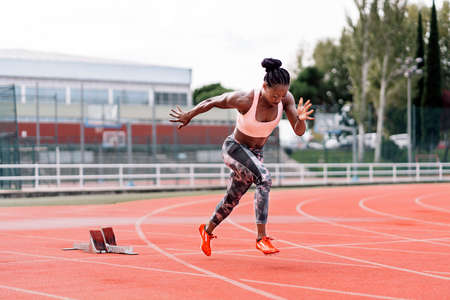 Young beautiful athlete sprinter runningの写真素材