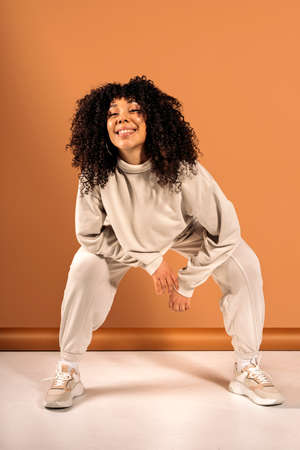 Stock photo of cool african american dancer posing in studio shot against brown background.の写真素材