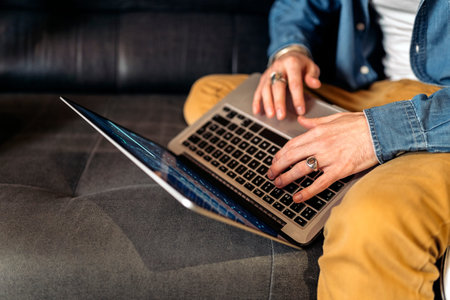 Stock photo of unrecognized music producer using laptop in the music studio.
