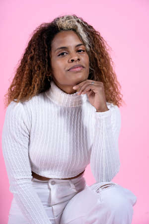 Stock photo of beautiful woman with curly hair posing during studio shot.の写真素材