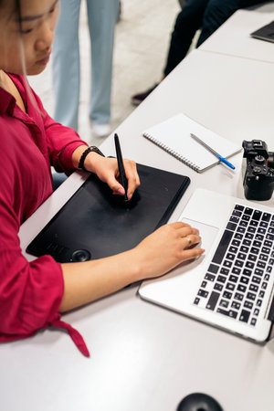 Asian female office worker sitting in her desk in the office and using her laptop.の写真素材