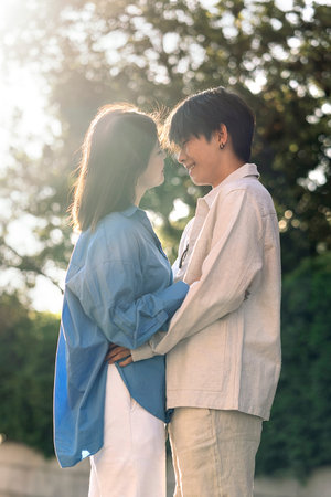 Cool and young asian looking at each other and kissing in the city.