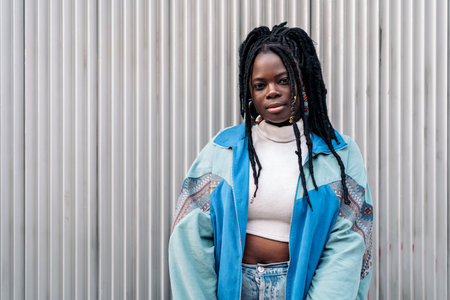 Beautiful young african woman looking at camera outdoors and posing.の写真素材