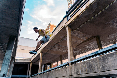 Talented young man practicing parkour tricks in the city and having fun.の写真素材