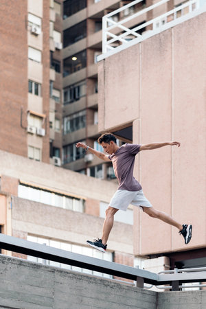 Young handsome man practicing parkour in the city and training.の写真素材