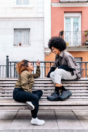 Stock photo of cool afro girls talking and looking at each other.の写真素材