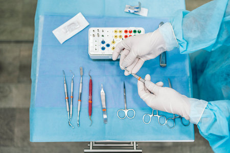 Stock photo of unrecognized dentist using special equipment for surgery procedure.の写真素材