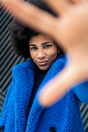 Stock photo of beautiful african american girl posing and looking at camera over black background.の写真素材