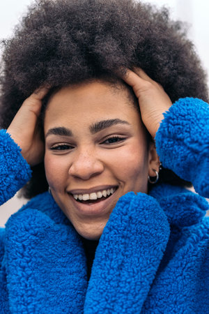 Stock photo of beautiful african american girl smiling and looking at camera.