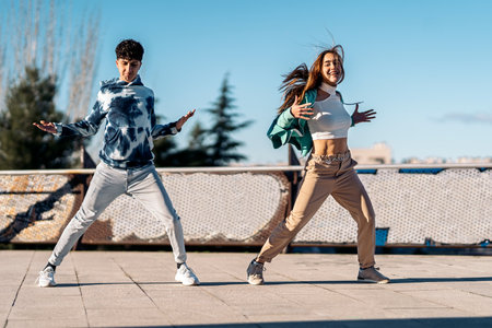 Stock photo of cool girl and her friend practicing their dance moves and having fun.の写真素材