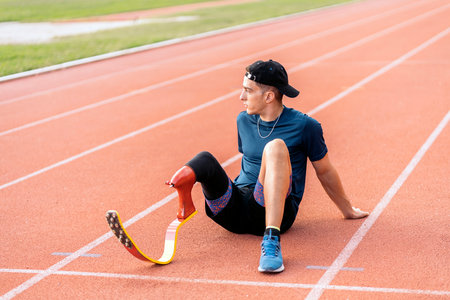 Stock photo of disabled man athlete taking a break. Paralympic Sports Concept.の写真素材