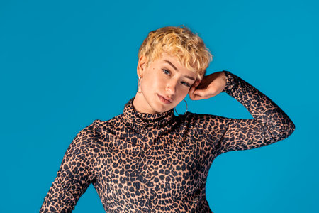 Stock photo of expressive girl wearing animal print shirt looking at camera and smiling.の写真素材