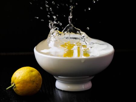 small orange in cup with waterの写真素材