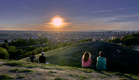 We all watch the sunset over the big cityの写真素材