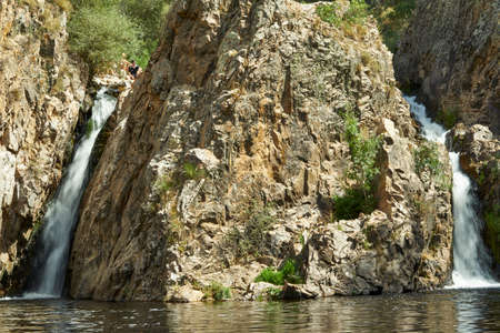 two waterfalls on the mountainsの写真素材