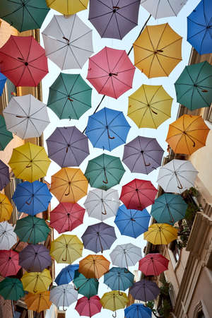 colorful umbrellas adorn the streetsの写真素材
