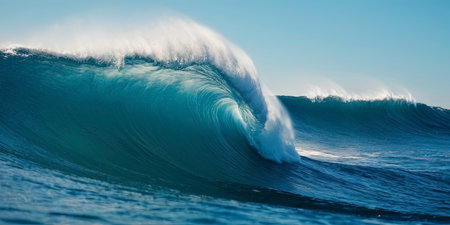 Surfing ocean wave. Blue ocean wave with white foam and blue skyの素材
