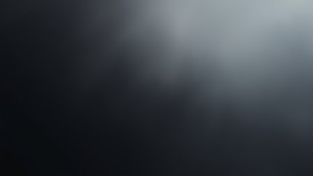 A sophisticated abstract dark background showcases a smooth gradient of grey and black tones, ideal for various design applications. This modern and stylish image presents a subtle texture with a seamless blend, creating an elegant and calm atmosphere. Perfect as a wallpaper, backdrop, or overlay, this monochrome design provides an empty space for text or graphics, making it suitable for darkmode interfaces, minimalistic projects, and creative backgrounds. Its sleek surface offers a versatile foundation for digital and graphic design needs.の素材