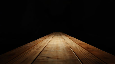 A dramatic spotlight illuminates a wooden plank perspective against a deep black background. This image showcases the natural texture and grain of aged wood, creating an alluring visual. The play of light and shadow accentuates the surface, offering a compelling abstract concept. Ideal for design projects, presentations, or as a rustic background, this image provides an empty space for text or graphic overlay, suitable for showcasing products or conveying a sense of depth and history.の素材