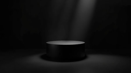 A sleek, black cylinder podium is dramatically illuminated by a spotlight against a deep dark backdrop, creating a striking visual. This 3D render features strong shadow play and highlights the minimalist design of the cylinder platform, ideal for product placement or product display. The isolated element exudes luxury and elegance, offering a clean and modern aesthetic for advertising, marketing, and presentation needs. Utilize this image to showcase your brand in an exhibition or for creating a stunning mock-up. The empty space allows for versatile application.の素材