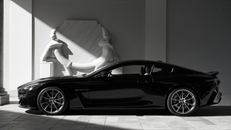 A black sports car is parked near a white sculpture, with sunlight creating shadows on the stone pavement.の素材