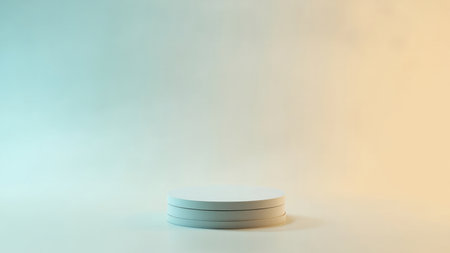 White cylindrical podium on a gradient teal and yellow background with soft lighting and shadows.の素材