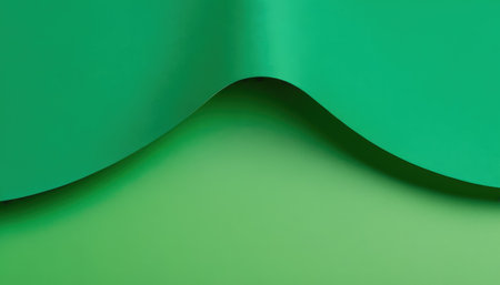 Green paper curved corner on green background, copy space for text.の素材
