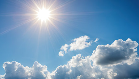 Blue sky background with clouds and sun. Beautiful sky with clouds.の素材