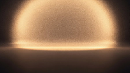A soft, diffused golden light emanates from the top of the frame, creating a luminous halo effect against a darker background. The light has a grainy texture, suggesting a subtle atmospheric quality or a digital effect. A thin, bright horizontal line of light appears at the bottom of the illuminated area, casting a gentle glow on the dark foreground.の素材