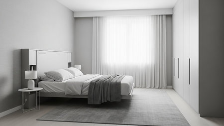 A modern and minimalist bedroom with a clean, uncluttered aesthetic. A white bed with crisp white bedding and a grey knitted throw is the central focus. A small white nightstand with a lamp sits beside the bed. Sheer white curtains cover a large window, allowing soft light to enter. A sleek grey wardrobe is visible on the right.の素材