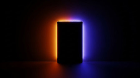 A dark, rectangular object stands in the center of a dark space, illuminated by vibrant orange light on the left and electric blue light on the right. The light creates a glowing outline around the object, casting soft shadows and highlighting the textured surface of the floor. The overall mood is mysterious and futuristic.の素材