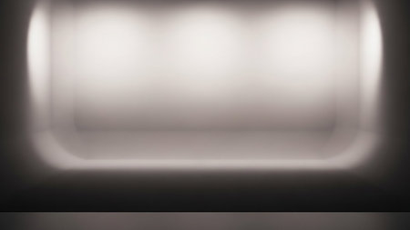 A softly lit, empty studio background with a subtle spotlight effect creating a bright, glowing area in the center. The edges are softly rounded, and the overall tone is neutral, with shades of grey and white. This minimalist and clean space is suitable for product displays or presentations, offering ample copy space.の素材