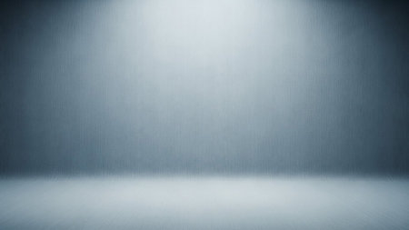 An empty studio background with a subtle textured wall and floor. The lighting creates a soft gradient effect, with a brighter, diffused light source at the top center of the wall, casting a gentle glow downwards. The texture appears to be a fine, brushed metallic or linen-like pattern, giving a sophisticated and clean look. The scene is devoid of any objects, making it suitable for product placement or presentations.の素材