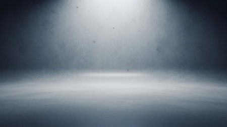 A dark and atmospheric studio background with a textured concrete surface. A bright spotlight shines down from above, casting a pool of light on the floor and creating a dramatic shadow effect. The overall impression is minimalist and industrial, suitable for product photography or dramatic scenes.の素材