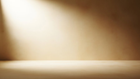 A warm-toned interior space with a textured wall and floor in shades of beige and brown. A strong beam of light enters from the left, casting a dramatic spotlight effect across the wall and illuminating the floor. The atmosphere is soft and moody, with subtle shadows.の素材