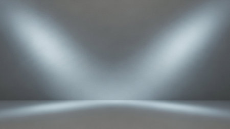 An empty interior studio space with a textured gray wall and floor. Two bright, white spotlights illuminate the wall from above, creating distinct beams of light and subtle shadows. The scene is clean, minimalist, and suitable for product display or presentations.の素材