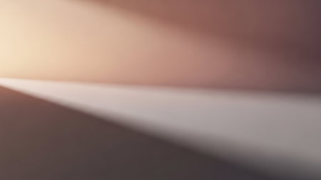An abstract image created by the interplay of light and shadow on a subtly textured surface. Soft gradients of warm and cool tones, including beige, brown, and grey, create a minimalist and atmospheric composition with a diagonal light beam.の素材