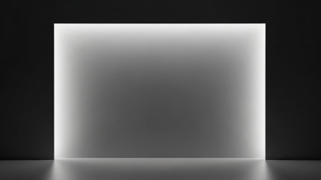 A minimalist, abstract image featuring a brightly lit rectangular opening against a dark background. The light emanates from the top and sides, creating a soft gradient that fades towards the center. The floor reflects the light, adding depth to the scene.の素材