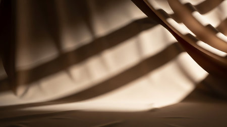A close-up view of soft, draped fabric in a neutral tone, with strong diagonal shadows creating a dramatic and abstract pattern across the surface.の素材